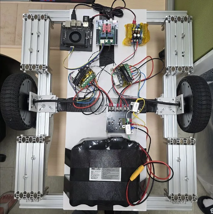 Real in-progress autonomous mobile robot chassis with wheels, frame, and wiring